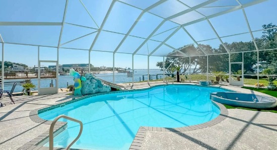 Screened private pool with a slide at Lucky View vacation rental overlooking the water near Pensacola